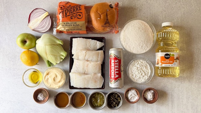 Crispy beer-battered fish sandwich with fennel slaw ingredients on countertop