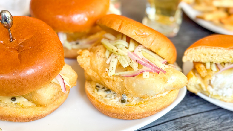 Crispy beer-battered fish sandwiches with fennel slaw on serving platter