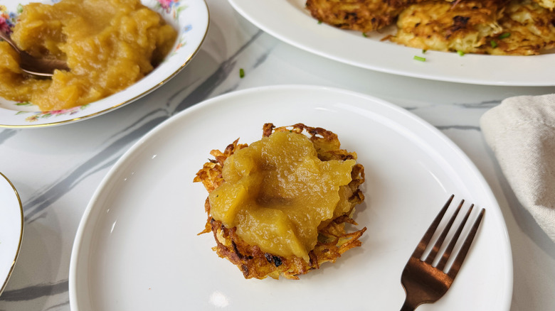 Latke topped with applesauce