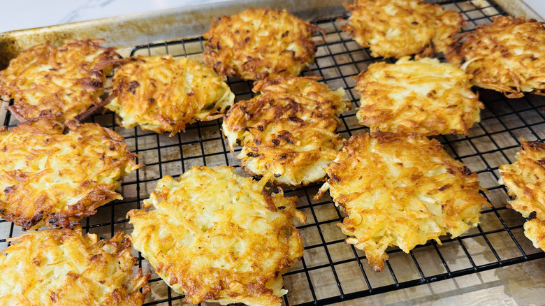 Latkes draining on a wire rack