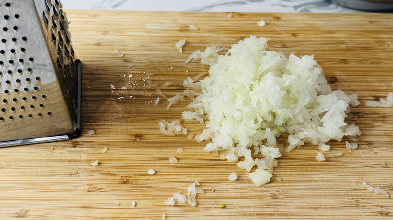 Grating onions on cutting board