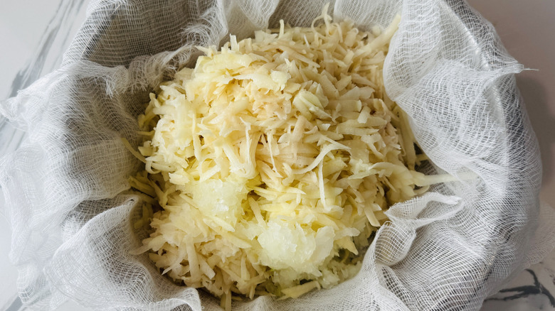 Latke mixture in cheesecloth