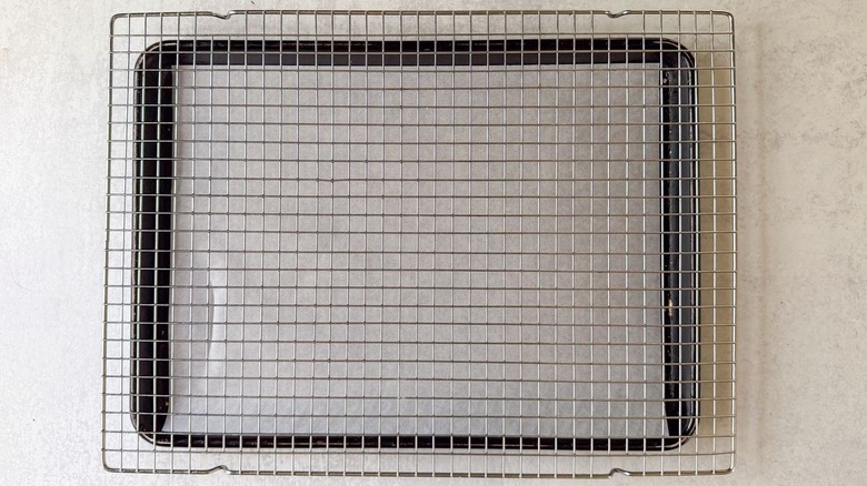 Baking sheet lined with parchment paper and fitted with a rack