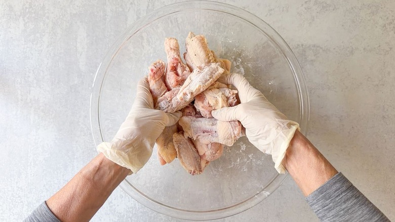 Tossing chicken wings with dry brine