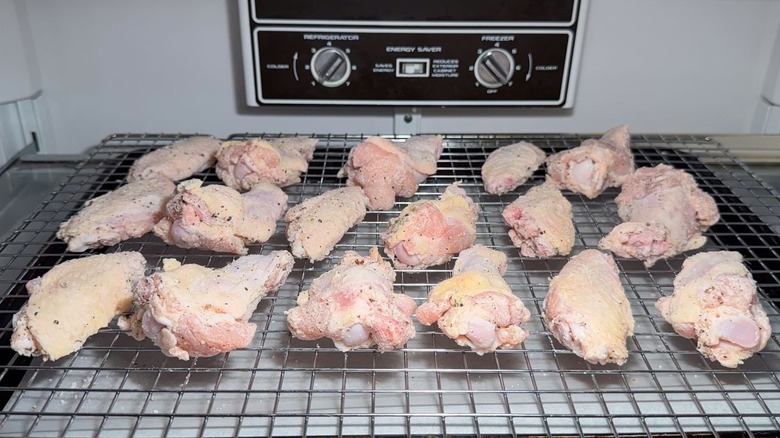 Chicken wings drying on rack in refrigerator