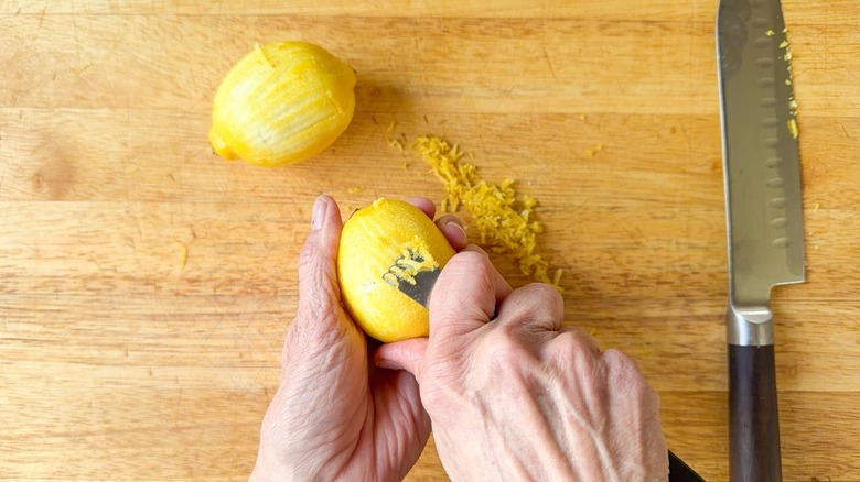 Zesting lemons on cutting board