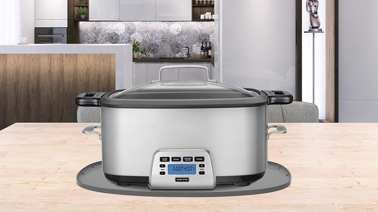 Slow cooker on a heat resistant mat on countertop