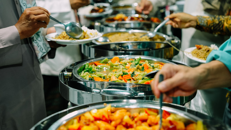 Diners serving themselves from a buffet line