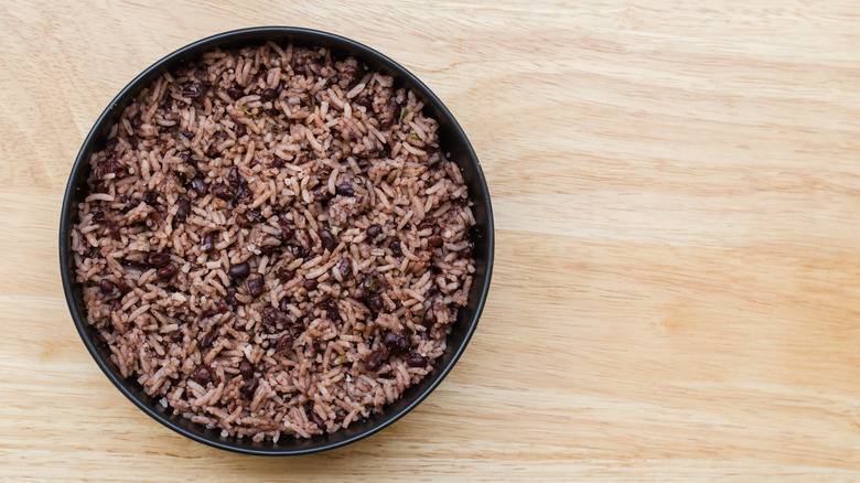 A bowl of Cuban rice and beans on wooden table