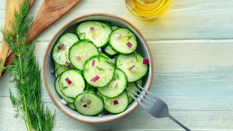 Cucumber salad with dill and red onions in a bowl