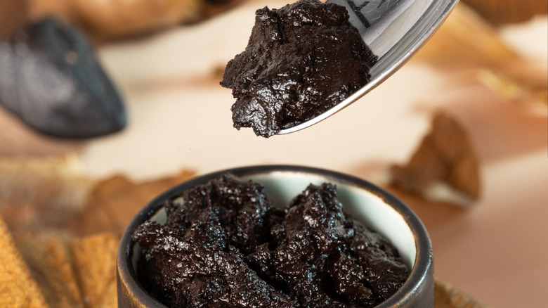 A jar of creamy black garlic spread