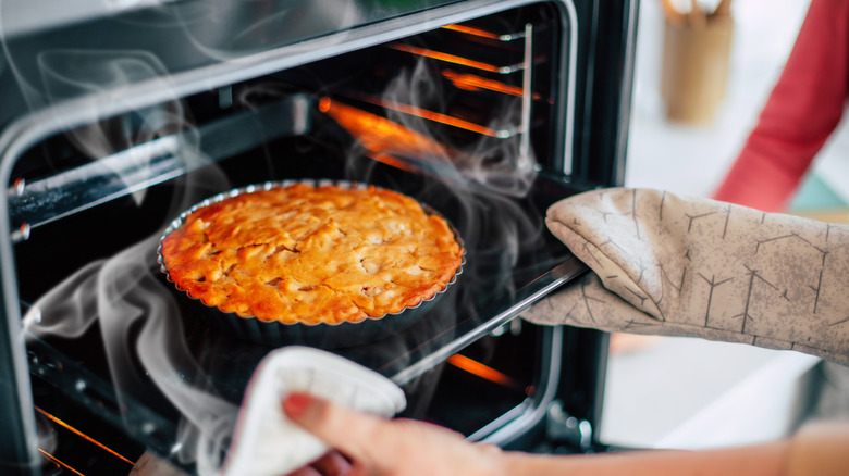 Person taking baked pastry out of the oven