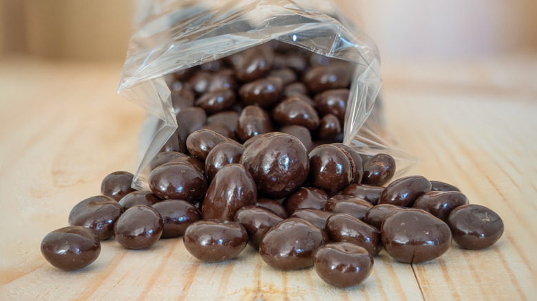 chocolate covered espresso beans spilling out of a bag