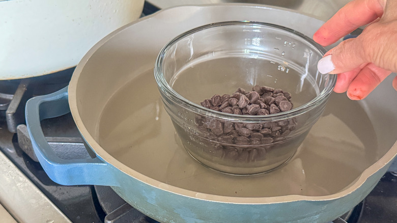 chocolate in glass bowl in pan with water