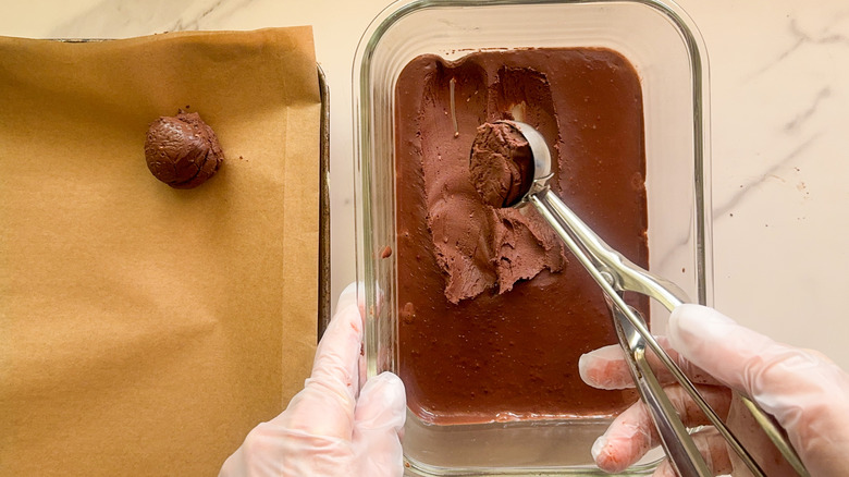 hand scooping out ganache balls