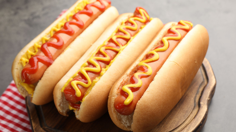 Close up on three hot dogs with ketchup and mustard