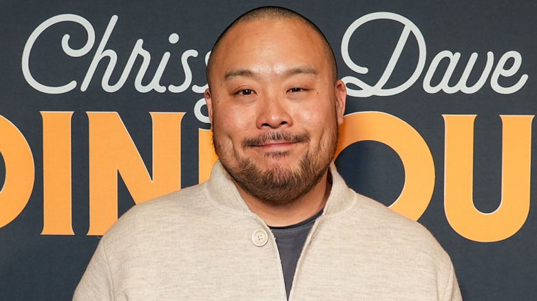 Chef David Chang smiles at a red carpet event.