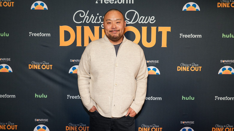 Chef David Chang smiles at a red carpet event.