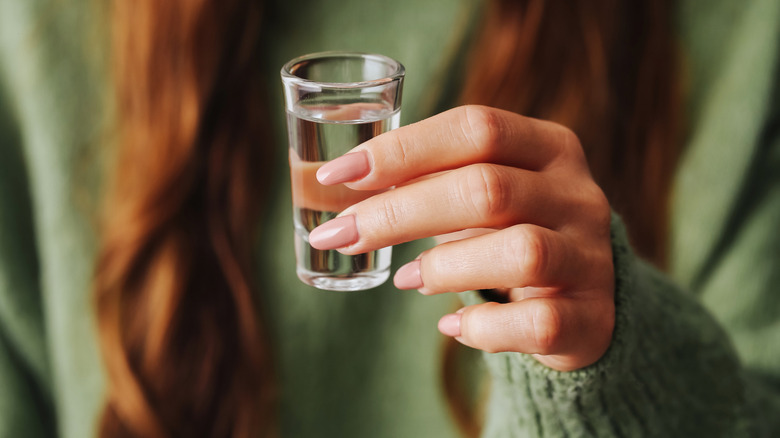 girl holding shot