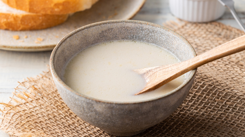 A bowl of simple potato soup on a table
