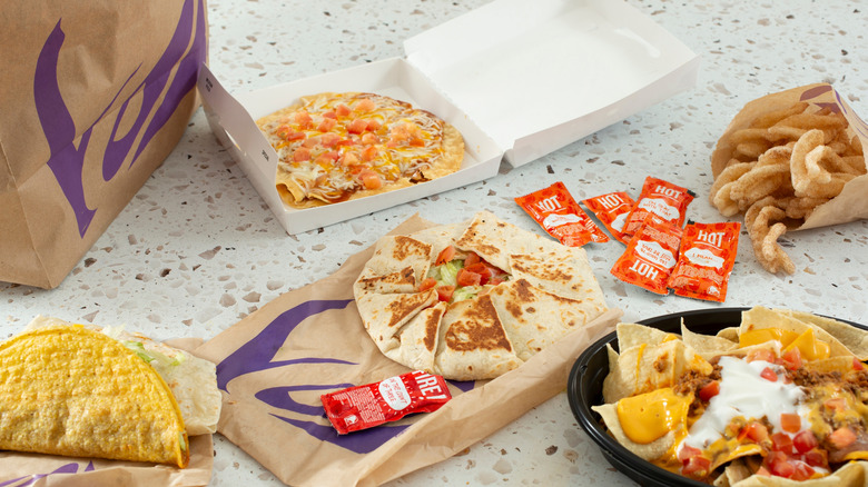 various Taco Bell items and packaging spread out on a counter