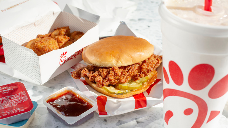 A delicious, crispy chicken sandwich topped with pickles with Chick-fil-A sides