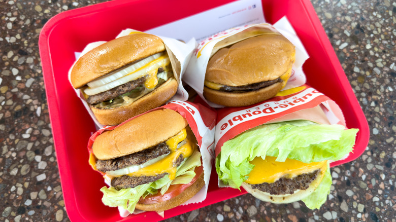 four In-N-Out burgers on a tray