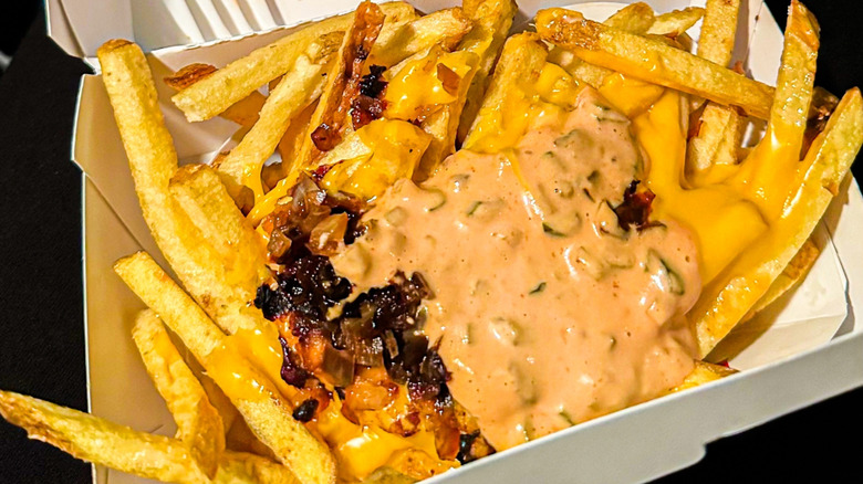 An order of In-N-Out Animal Style fries, which consists of cheese, Thousand Island spread, and grilled onions piled over the basket of fries
