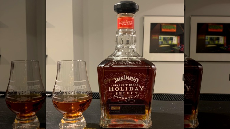 A bottle of Jack Daniel's Holiday Select from 2014 with a glass of it