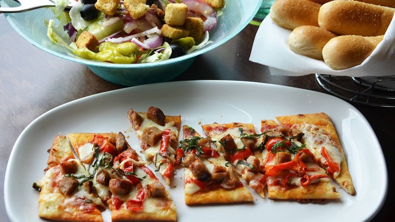 A flatbread pizza on a plate at Olive Garden