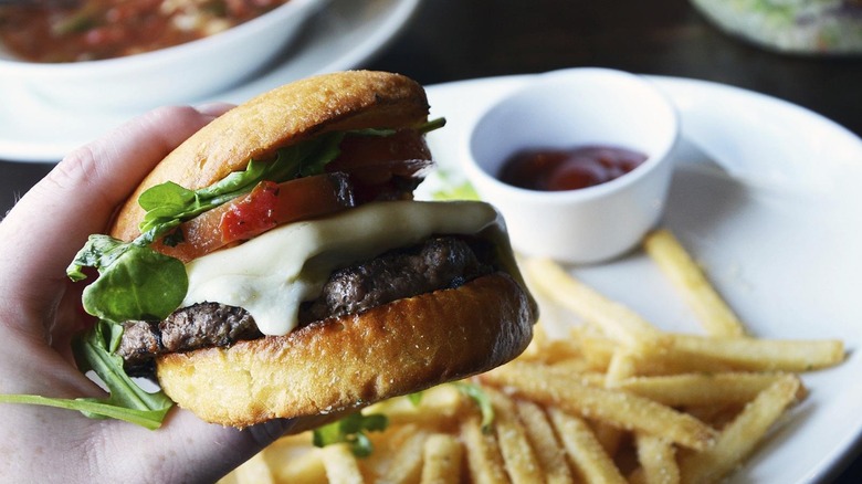 A person holding an Italiano Burger at Olive Garden