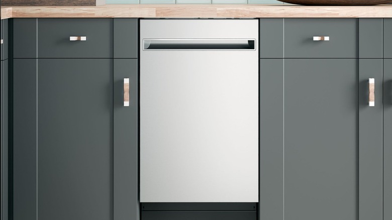 Haier dishwasher installed in a kitchen with grey cabinets