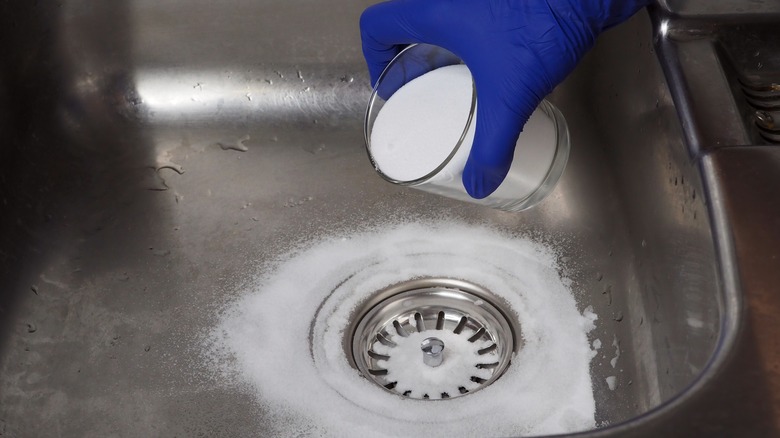 Pouring baking soda down drain