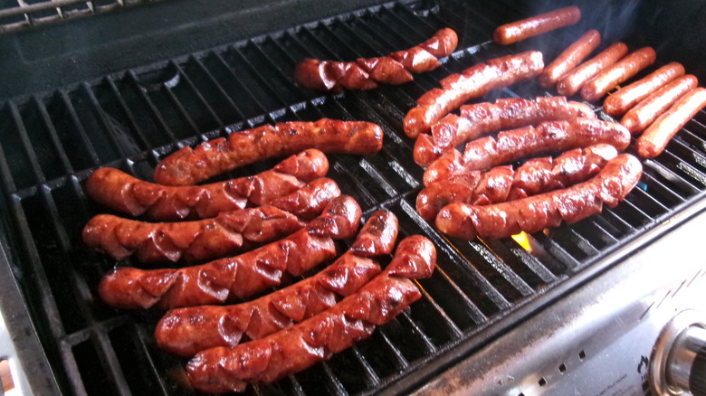 hot dogs cooking on the grill