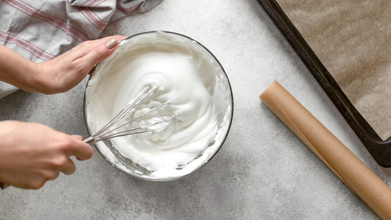 Whipped cream being whisked.
