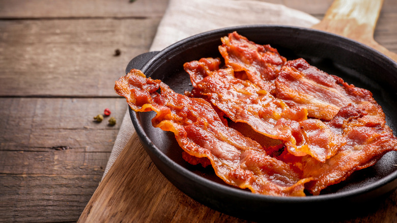 Hot crispy bacon in a skillet.