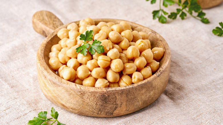 Cooked chickpeas in a wooden bowl.