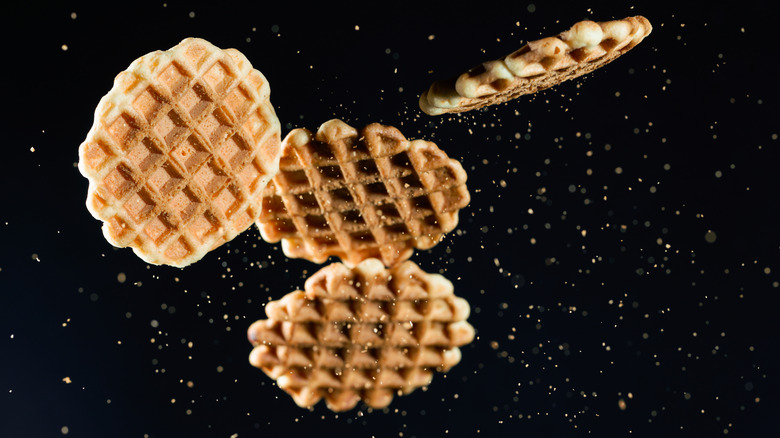 four round wafles falling amid seasoning debris