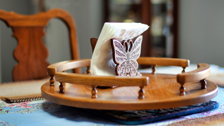 whimsical wood lazy Susan with an engraved butterfly in the middle of a table