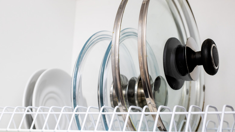 Glass pot lids in a white wire dish drainer