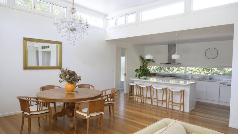 Dining room and kitchen with a chandelier