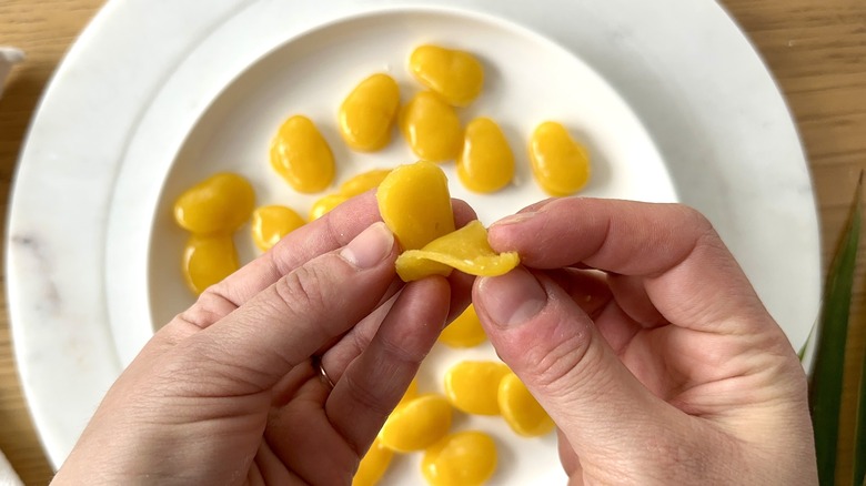 hands holding mango candy