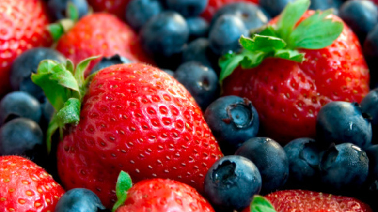 A close-up of strawberries and blueberries