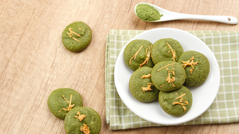 matcha cookies on table with spoon of matcha powder