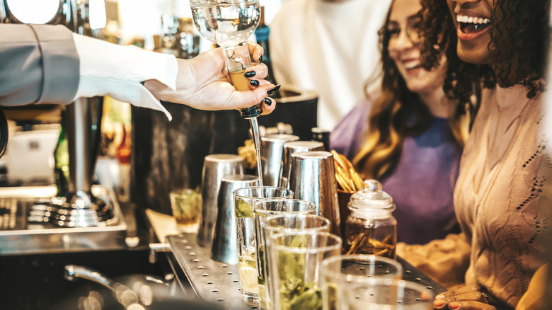 Bartender pouring drinks for customers