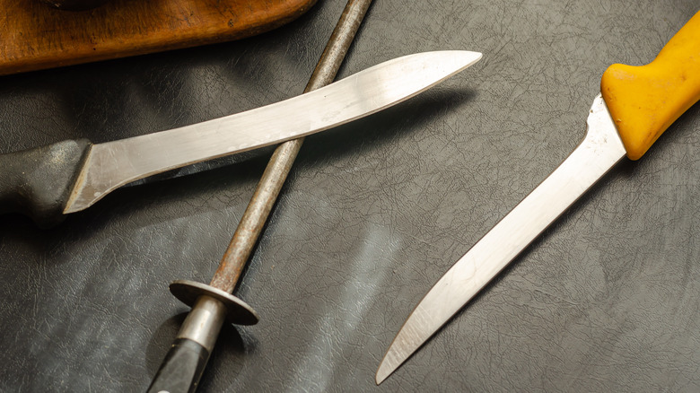 Pair of boning knives on black background