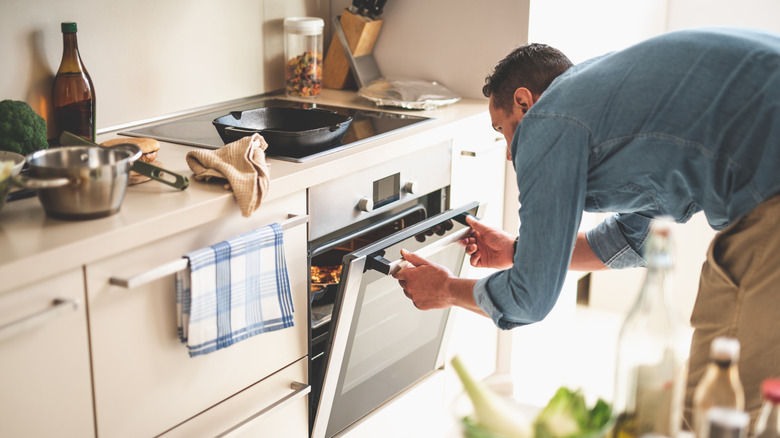 Person opening oven door