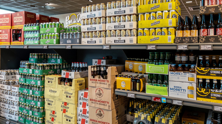Canned beers and bottles in grocery store