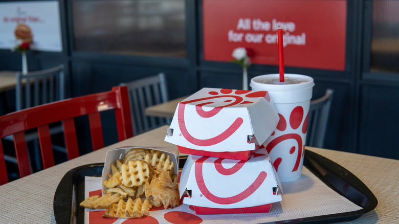 Chick-fil-A meal with waffle fries, two Chick-fil-A boxes, and a drink cup