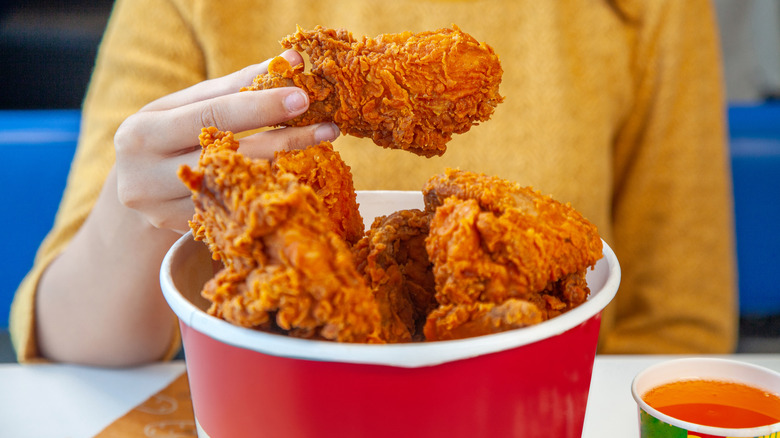 Person with a bucket of fried chicken